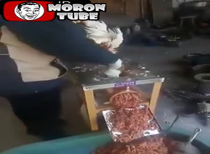 Video :Feathers from chickens being chopped using an electric chopper